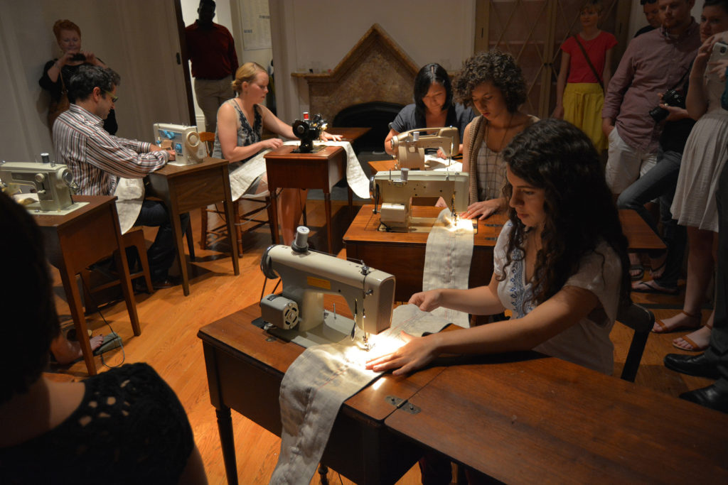 Melissa Ann Vandenberg, Machine Mandala. Sewing machines, linen, thread, chairs, & audience participants, 2014.