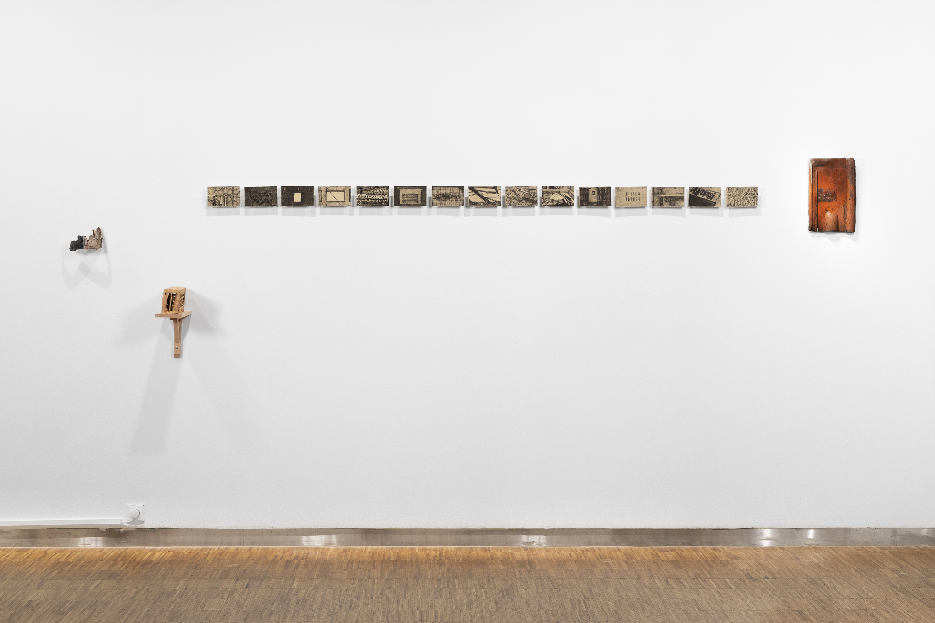 Milton Mondal, Title: When the root is abandoned-II, Technique: Lithography, ceramic & print transfer on tree bark, Year:2025, Photo: Istvan Virag
